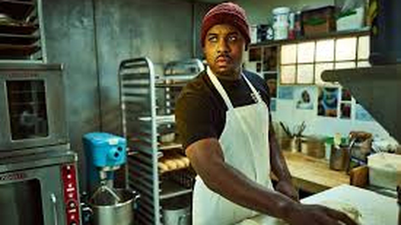 Marcus working dough alone in the bakery &mdash; The Bear, season 1. Quiet rigour. The loop. The wall above the bench reads: every second counts.